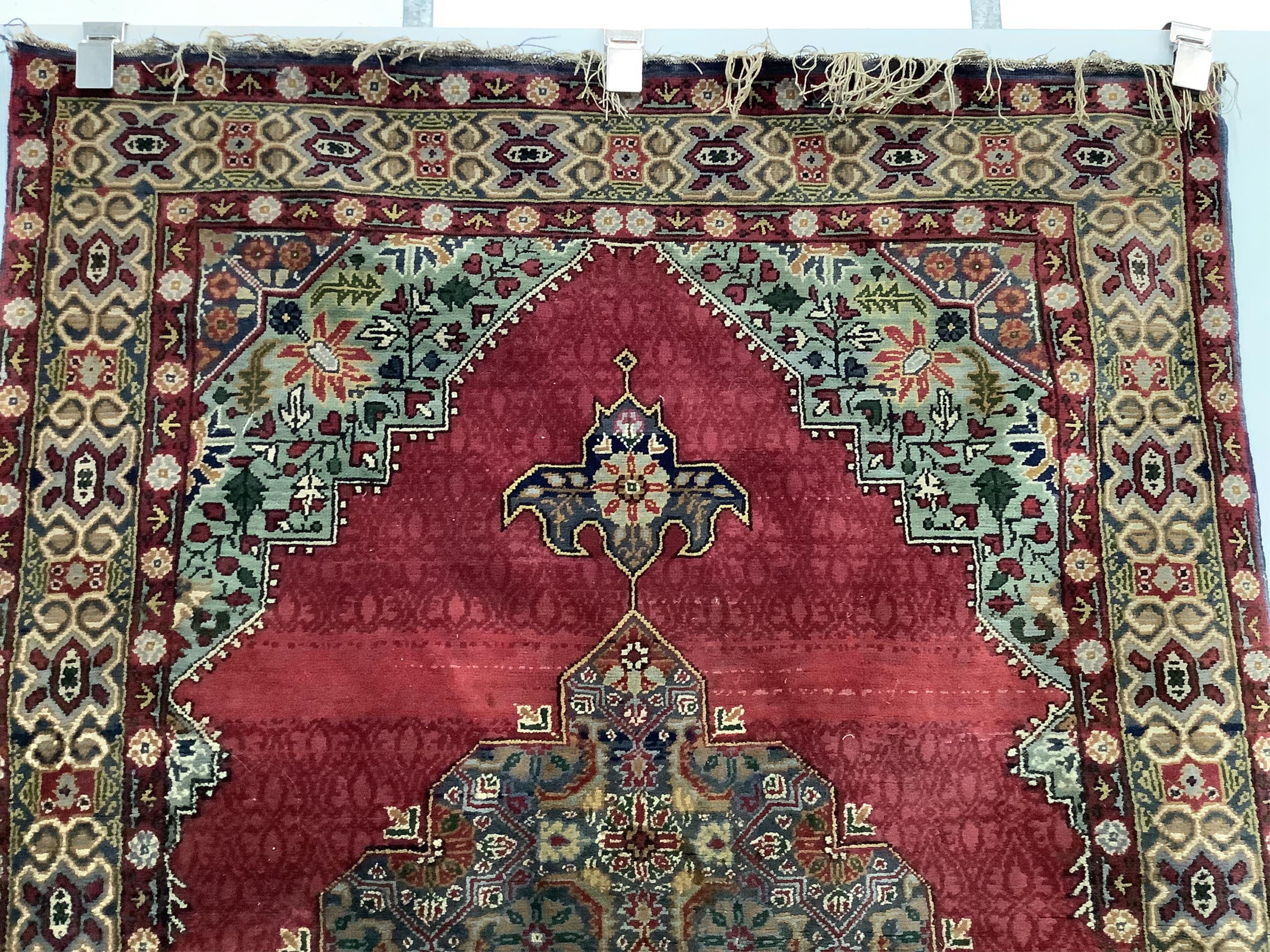 A North West Persian red ground rug, 170 x 106cm. Condition - faded and worn at the fringes